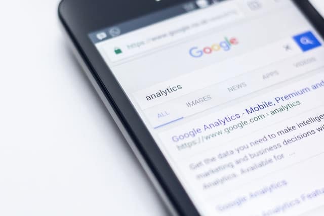 Phone with Google opened on it and analytics typed into the search bar